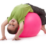 Little boy doing gymnastic exercises