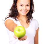 girl holding apple