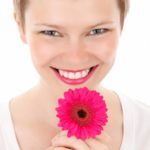 smiling woman with a flower