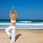 Healthy yoga exercise on the beach